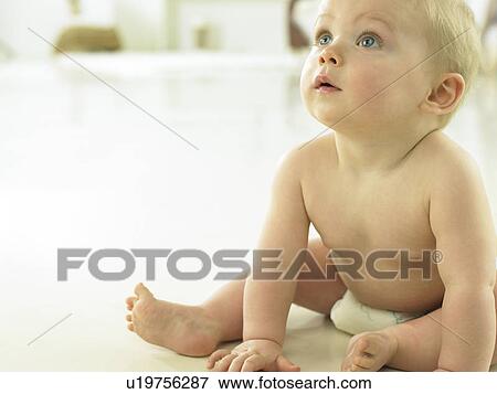 Stock Photo - Baby sitting and looking upwards. Fotosearch