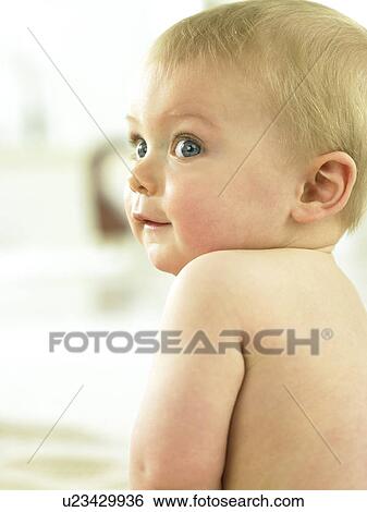 Baby sitting looking over shoulder View Large Photo Image Stock Photograph - Baby sitting looking over shoulder. Fotosearch