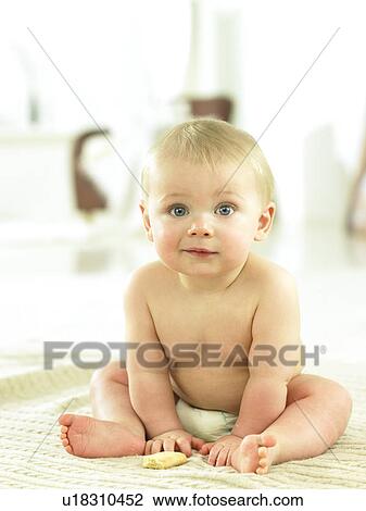 Baby sitting with a cookie View Large Photo Image Stock Image - Baby sitting with a cookie. Fotosearch