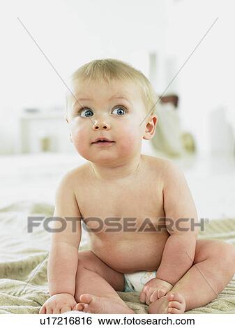 Baby sitting with wide eyes View Large Photo Image Stock Photograph - Baby sitting with wide eyes. Fotosearch