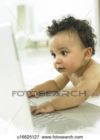 Stock Photo - Baby with a laptop. Fotosearch