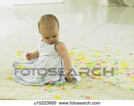 Baby with confetti around her View Large Photo Image Stock Image - Baby with confetti around her. Fotosearch