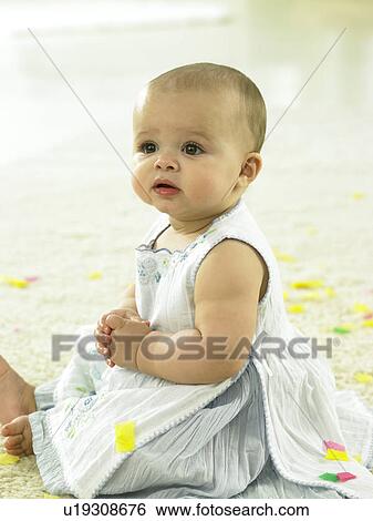 Baby with confetti around her View Large Photo Image Stock Photograph - Baby with confetti around her. Fotosearch