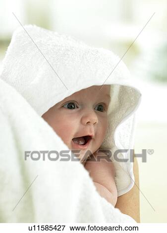 Baby with towel over head being held View Large Photo Image Stock Photo - Baby with towel over head being held. Fotosearch