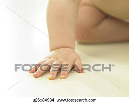 Baby's hand on floor View Large Photo Image Picture - Baby's hand on floor. Fotosearch