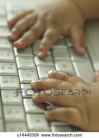 Stock Photo - Baby's hands at a computer keyboard. Fotosearch