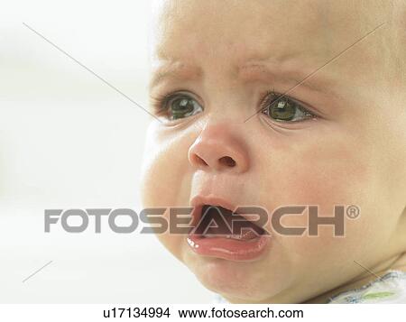 Picture - Baby's face close up crying. Fotosearch