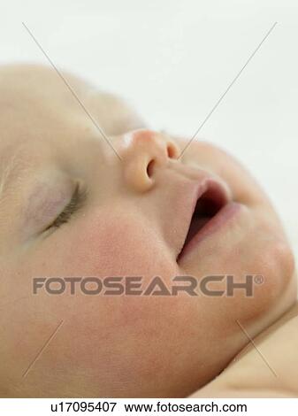 Baby's face close up sleeping View Large Photo Image Stock Photo - Baby's face close up sleeping. Fotosearch