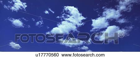 Blue skies with clouds View Large Photo Image Stock Image - Blue skies with clouds. Fotosearch
