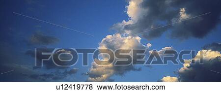 Blue skies with clouds View Large Photo Image Stock Photo - Blue skies with clouds. Fotosearch