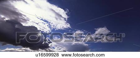 Blue skies with clouds View Large Photo Image Stock Photo - Blue skies with clouds. Fotosearch