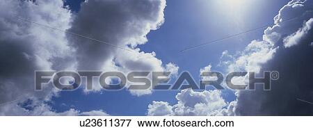 Blue skies with clouds View Large Photo Image Stock Photo - Blue skies with clouds. Fotosearch