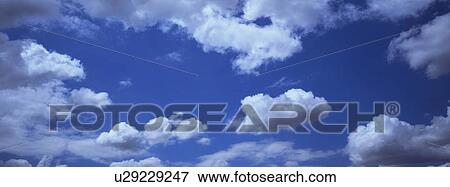 Blue skies with clouds View Large Photo Image Stock Photo - Blue skies with clouds. Fotosearch