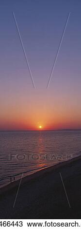 Stock Image - Beach shoreline at dusk. Fotosearch