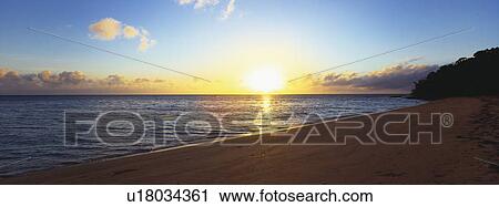 Stock Image - Beach shoreline at dusk. Fotosearch