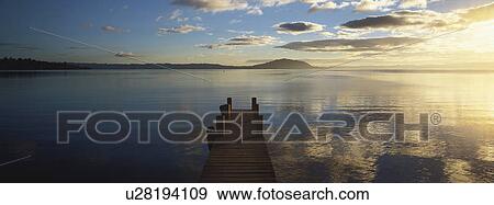 Landscape view with body of water and dock View Large Photo Image Stock Photo - Landscape view with body of water and dock. Fotosearch