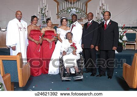 African American bride and groom posing at a church alter with the wedding party, minister and an elderly woman in a wheelchair after a wedding service. View Large Photo Image Stock Image - African American bride and groom posing at a church alter with the wedding party, minister and an elderly woman in a wheelchair after a wedding service.. Fotosearch