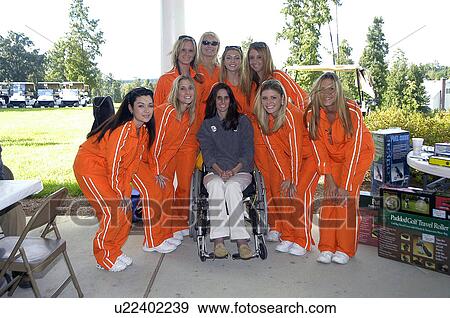 Attractive young woman with physical disabilities sitting in her wheelchair, posing in a group photo shot with seven female golf team players who are dressed in matching sweat suits. View Large Photo Image Stock Photo - Attractive young woman with physical disabilities sitting in her wheelchair, posing in a group photo shot with seven female golf team players who are dressed in matching sweat suits.. Fotosearch