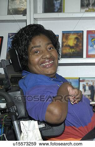 Face of a woman with disabilities û browsing in a video rental store. View Large Photo Image Stock Photo - Face of a woman with disabilities û browsing in a video rental store.. Fotosearch
