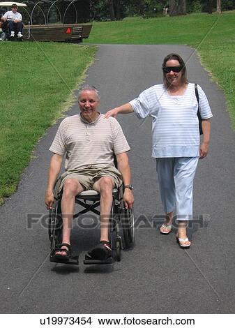 Man, in a wheelchair, and woman at Muscular Dystrophy Association Summer Camp. View Large Photo Image Picture - Man, in a wheelchair, and woman at Muscular Dystrophy Association Summer Camp.. Fotosearch