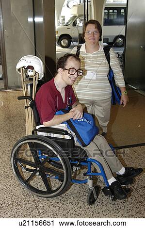 Man In Wheelchair And Woman In A Lobby Stock Image U21156651