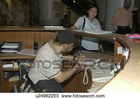 Man with a disability, utilizing a wheelchair for mobility, visiting an exhibit. View Large Photo Image Stock Image - Man with a disability, utilizing a wheelchair for mobility, visiting an exhibit.. Fotosearch