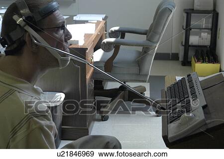 Man with significant disabilities utilizing headgear to operate communications apparatus. View Large Photo Image Stock Photo - Man with significant disabilities utilizing headgear to operate communications apparatus.. Fotosearch