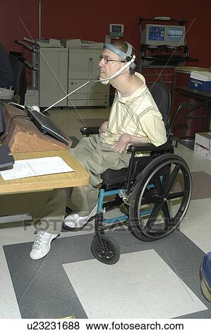 Man with significant disabilities utilizing headgear to operate communications apparatus. View Large Photo Image Stock Photo - Man with significant disabilities utilizing headgear to operate communications apparatus.. Fotosearch