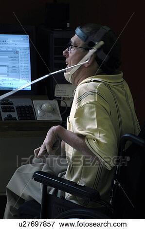Man with significant disabilities utilizing headgear to operate communications apparatus. View Large Photo Image Stock Photo - Man with significant disabilities utilizing headgear to operate communications apparatus.. Fotosearch