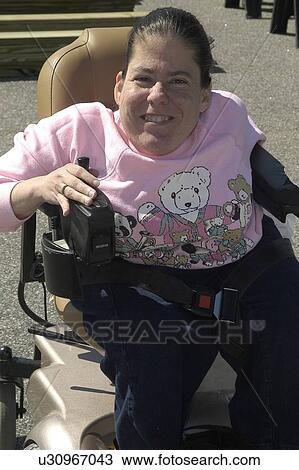 Medium shot of a young woman seated in a power wheelchair View Large Photo Image Stock Image - Medium shot of a young woman seated in a power wheelchair. Fotosearch
