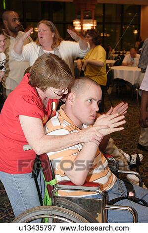 Stock Photo - Two adults with developmental disabilities enjoying dancing.. Fotosearch
