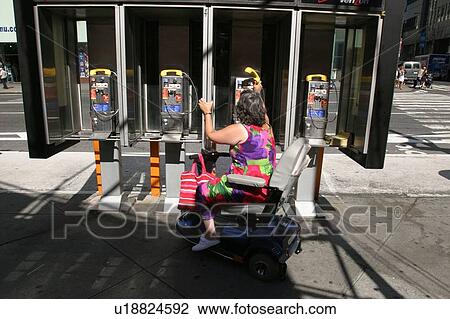 Woman trying to use a pay phone that is not accessible. View Large Photo Image Stock Image - Woman trying to use a pay phone that is not accessible.. Fotosearch