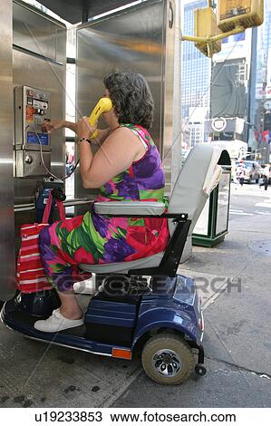 Woman using an accessible pay telephone. View Large Photo Image Stock Image - Woman using an accessible pay telephone.. Fotosearch
