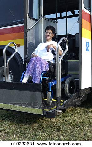 Woman with a disability riding on the accessible public transit system to get where she wants to go. View Large Photo Image Stock Image - Woman with a disability riding on the accessible public transit system to get where she wants to go.. Fotosearch