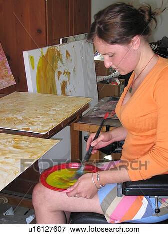 Young artist (female wheelchair user) mixes paint in her studio. View Large Photo Image Stock Photo - Young artist (female wheelchair user) mixes paint in her studio.. Fotosearch