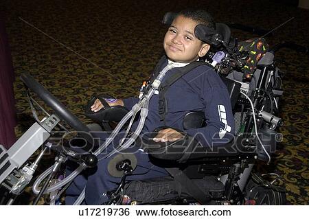 Stock Photograph - Young boy with significant disabilities getting around in the community with help from cutting edge assistive technology.. Fotosearch