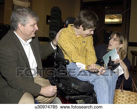 Young man with significant disabilities spending time with family and friends. View Large Photo Image Stock Photography - Young man with significant disabilities spending time with family and friends.. Fotosearch