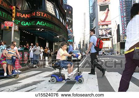 Boy using scooter to cross a street in New York City. View Large Photo Image Stock Photograph - Boy using scooter to cross a street in New York City.. Fotosearch