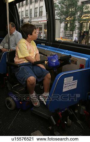 Boy utilizing a scooter/cart for mobility riding a bus to see the city. View Large Photo Image Stock Image - Boy utilizing a scooter/cart for mobility riding a bus to see the city.. Fotosearch