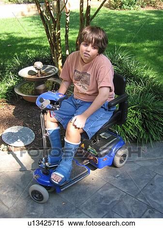 Boy, with Muscular Dystrophy, in his electric wheelchair, with casts, at his house. View Large Photo Image Stock Photography - Boy, with Muscular Dystrophy, in his electric wheelchair, with casts, at his house.. Fotosearch