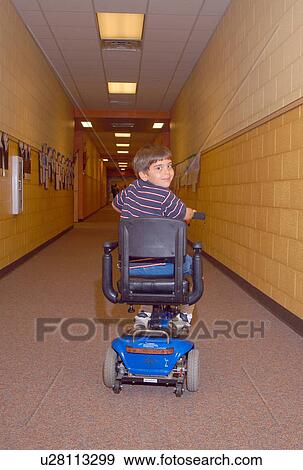 Boy with Muscular Dystrophy, utilizing a scooter/cart for mobility, heading home after a long day at school. View Large Photo Image Stock Photo - Boy with Muscular Dystrophy, utilizing a scooter/cart for mobility, heading home after a long day at school.. Fotosearch