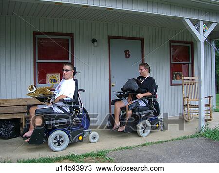 Boys, at camp, racing in their wheelchairs. View Large Photo Image Stock Image - Boys, at camp, racing in their wheelchairs.. Fotosearch