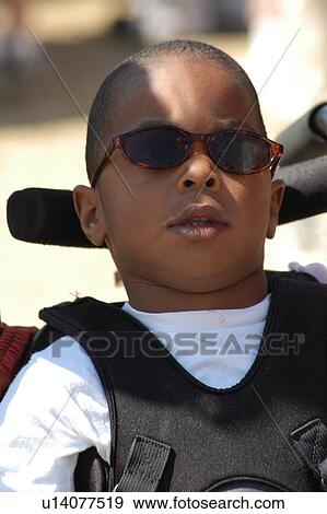 Cool little guy with multiple disabilities spending time outside on a sunny day. View Large Photo Image Stock Photo - Cool little guy with multiple disabilities spending time outside on a sunny day.. Fotosearch