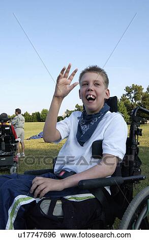 Excited boy with a disability waving to his friends. View Large Photo Image Stock Photograph - Excited boy with a disability waving to his friends.. Fotosearch