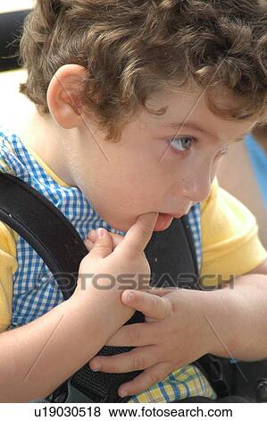 Stock Photo - Interesting expression/face of a little boy with multiple disabilities.. Fotosearch