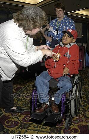 Stock Image - Little boy with multiple disabilities posing for the camera.. Fotosearch