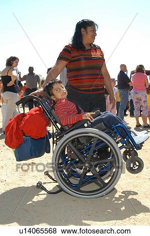 Little boy with multiple disabilities at an event with his mother. View Large Photo Image Stock Photo - Little boy with multiple disabilities at an event with his mother.. Fotosearch