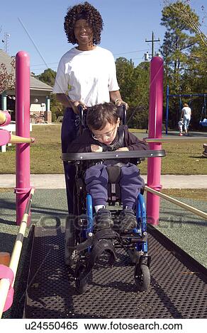 Little boy with multiple disabilities, utilizing a wheelchair for mobility, heading for the accessible playground to play with his friends. View Large Photo Image Stock Photography - Little boy with multiple disabilities, utilizing a wheelchair for mobility, heading for the accessible playground to play with his friends.. Fotosearch