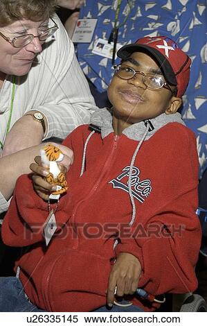 Little boy with multiple disabilities posing for the camera. View Large Photo Image Stock Photography - Little boy with multiple disabilities posing for the camera.. Fotosearch