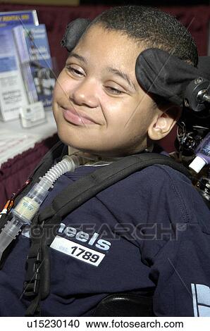 Little boy with significant disabilities utilizing a wheelchair with headgear for positioning and mobility. View Large Photo Image Stock Image - Little boy with significant disabilities utilizing a wheelchair with headgear for positioning and mobility.. Fotosearch